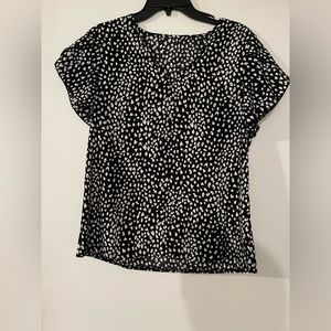 Small black and white women’s short sleeve blouse.